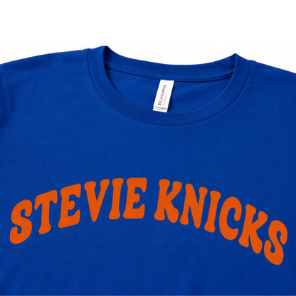 Close up of royal blue and orange Stevie Knicks NY Basketball funny shirt on a white background.
