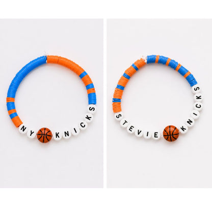 2 friendship beaded bracelets with orange and blue beads, basketball beads and letter beads "Stevie Knicks" "NY" sitting on light gray background.