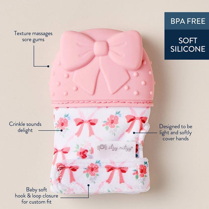 Itzy Mitt wearable pink bow silicone teething mitt teether with details of soft silicone and textured glove.