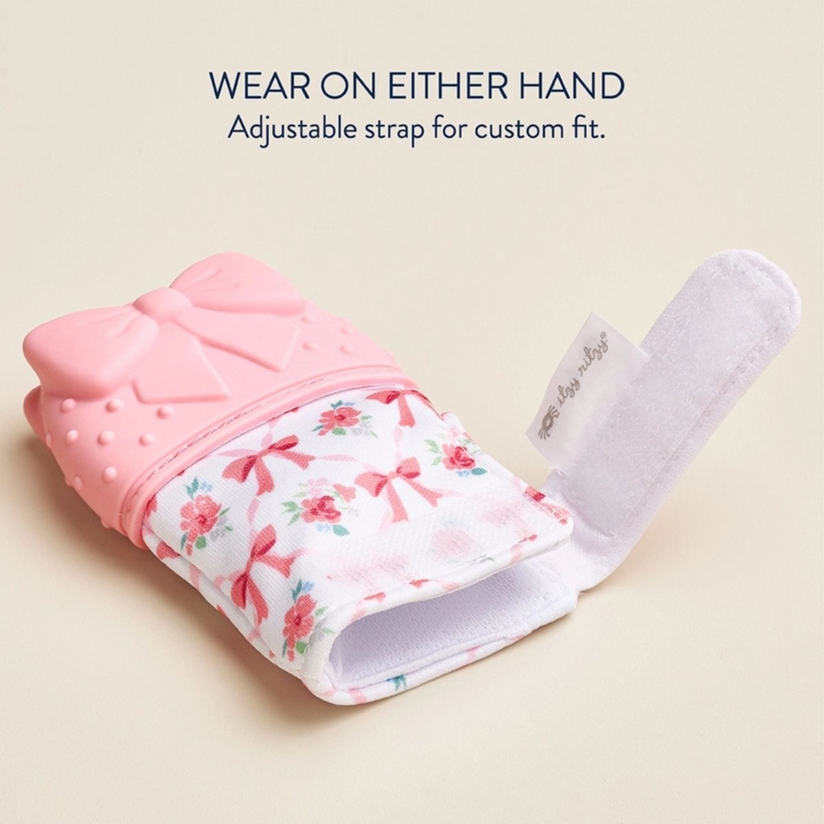 Itzy Mitt wearable pink bow silicone teething mitt teether with velcro opening for either hand.