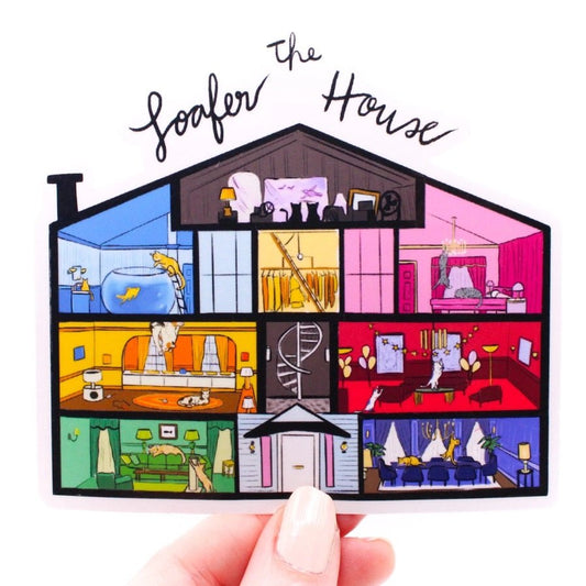 illustrated dollhouse style sticker with cats in each room "The Loafer House" being held up on white background. Little Gift Nook