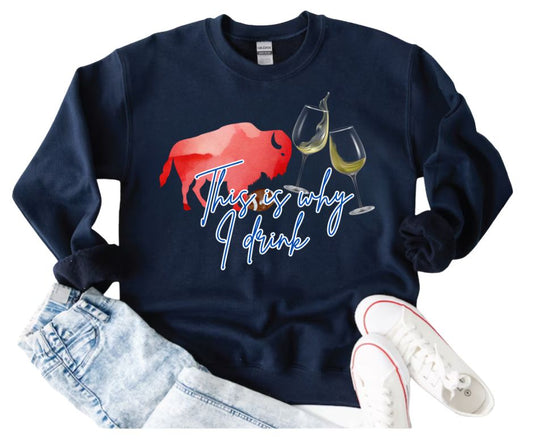Navy sweatshirt with red buffalo and wine glasses graphic and blue text "This is why I drink" laying on white background with jeans and running shoes. Little Gift Nook