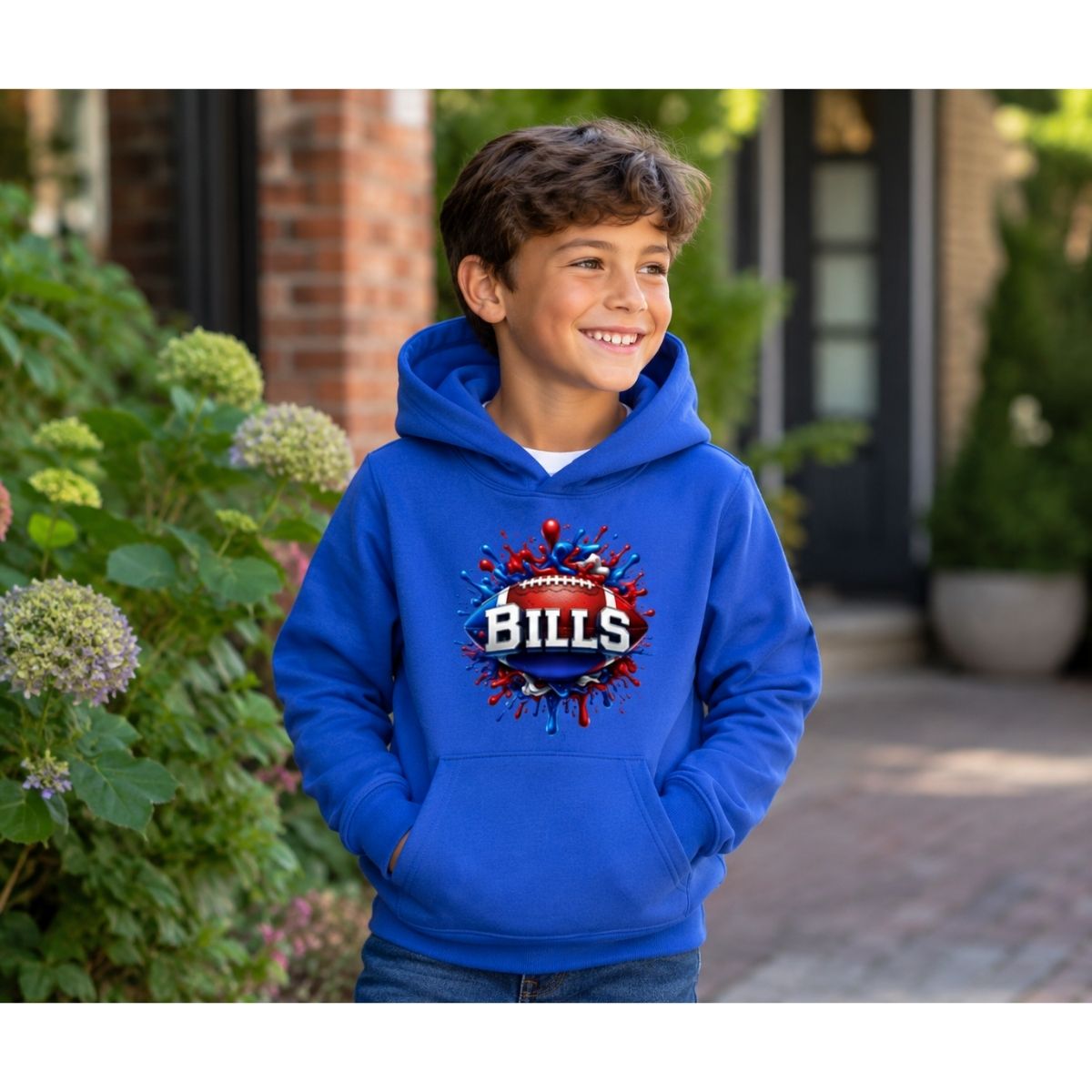 Boy wearing royal blue Bills football splatter paint hoodie outdoors.