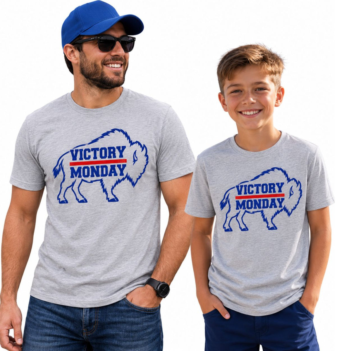 Man and boy wearing light gray t-shirts with royal blue and red Buffalo Silhouette outlines and "Victory Monday" text inside them on fronts standing on white background.