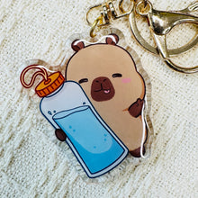 Load image into Gallery viewer, Capybara with water bottle acrylic keychain. Little Gift Nook.