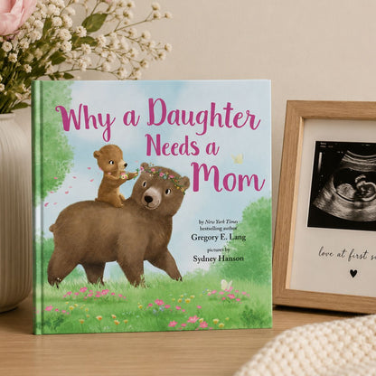 Book titled 'Why a Daughter Needs a Mom' with a bear illustration standing on wooden shelf with floral vase and ultrasound picture.