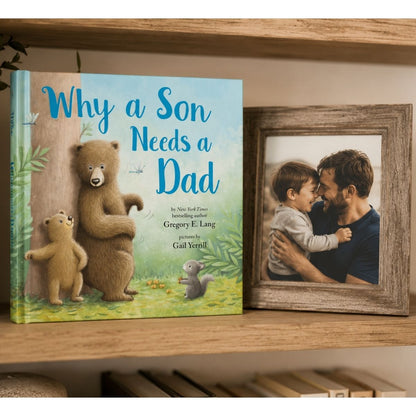 Book titled 'Why a Son Needs a Dad' with a framed photo of a man and child on a wooden shelf.