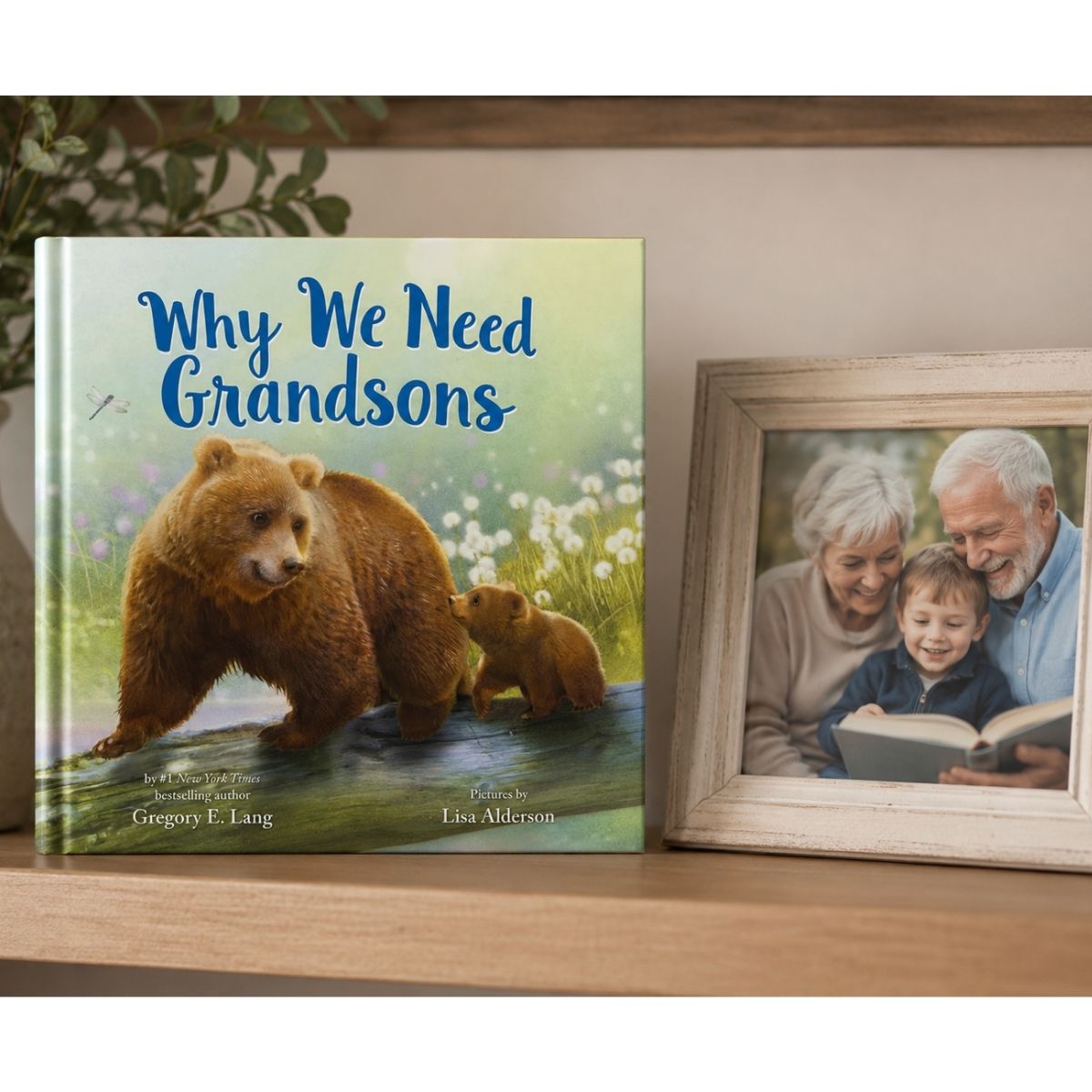 Book titled 'Why We Need Grandsons' with a bear illustration on a shelf next to a framed photo of grandparents and a grandson.