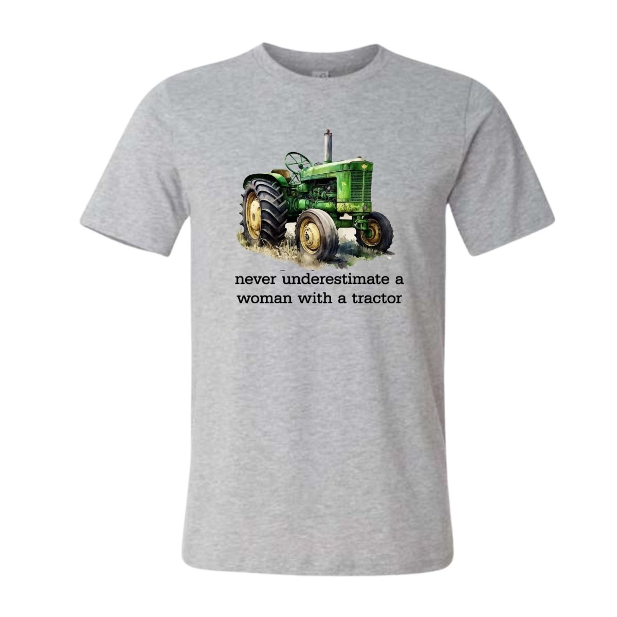 gray tractor t shirt with caption "never underestimate a woman with a tractor" on a white background. Little Gift Nook