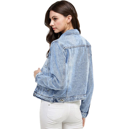 woman wearing light wash denim jacket back view.