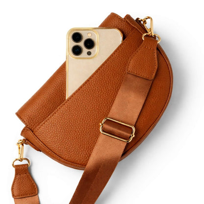 Kedzie Luna Chestnut brown cross body purse back pocket holding cell phone on a white background.