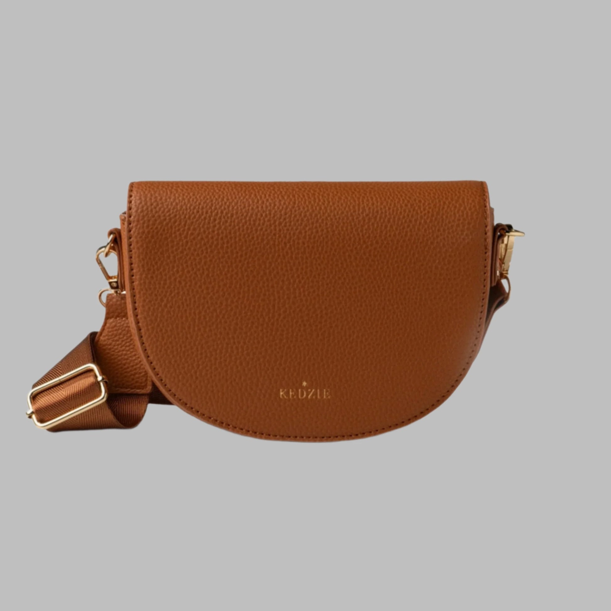 Brown Kenzie Chestnut purse handbag front facing with strap with gold accents on a gray background.