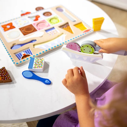Little Gift playing with Wooden Magnetic Ice Cream Puzzle on table. 