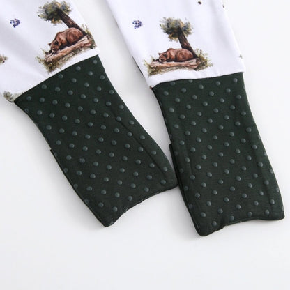 Baby bamboo white and forest green baby sleeper with fold over feet close up.