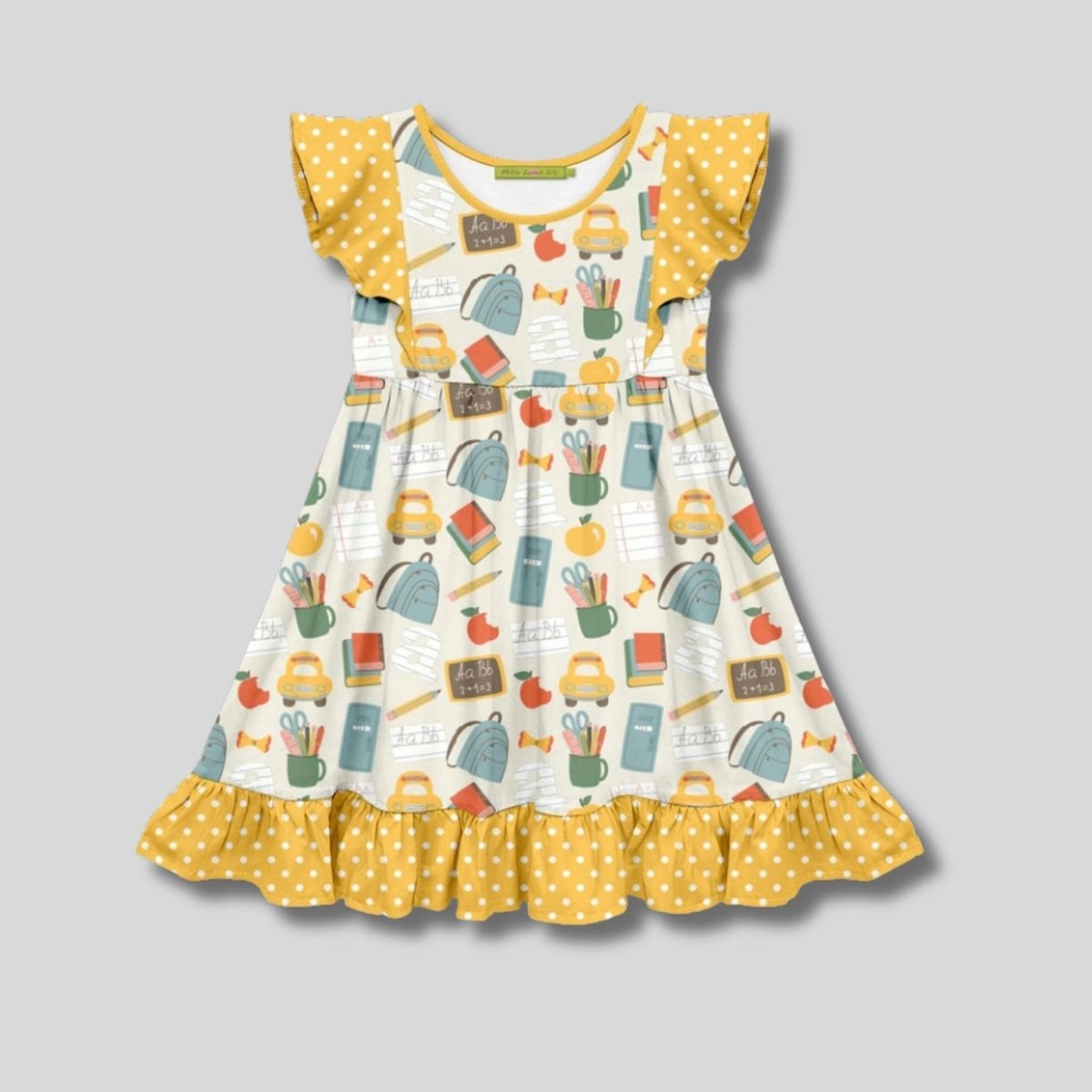 Children's dress with school-themed print and yellow polka dot details on a gray background. Little Gift Nook.