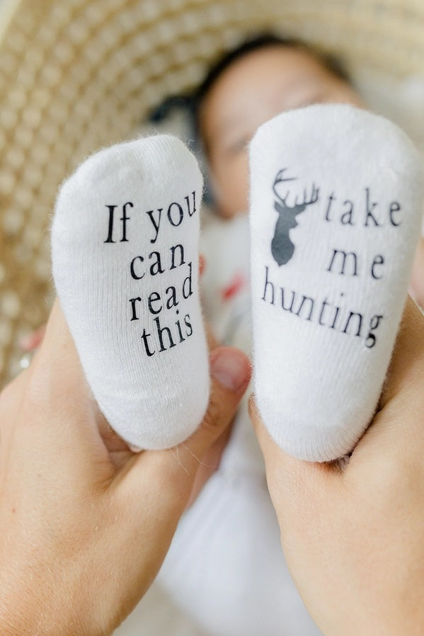 Baby white If you can red this Take me Hunting socks. Writing is on soles of feet. Comes in 2 sizes.
