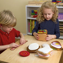 Load image into Gallery viewer, Melissa &amp; Doug Pretend Play Food Felt Sandwich Playset with kids building sandwhiches.