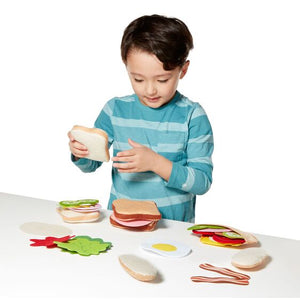 Melissa & Doug Pretend Play Food Felt Sandwich Playset. Little Boy Building a pretend sandwhich.