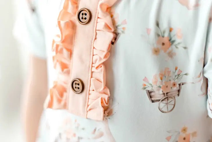 Honey Bunny Blue Eyelet Twirl Dress. Close up of front of dress floral print and ruffle accents. - Little Gift Nook