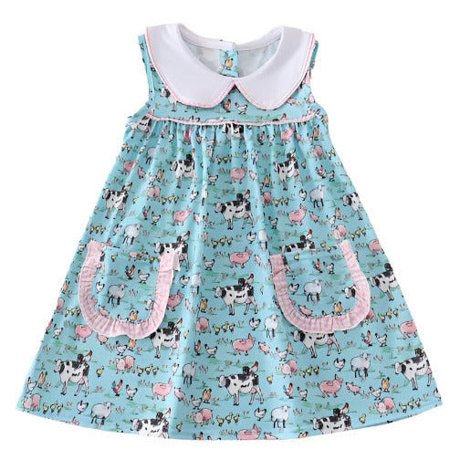 On the Farm Blue Pink Gingham Collar Pocket Dress. Baby blue sleeveless dress with black white cows and pink pigs print. Farm theme. White collar with gingham trim. - Little Gift Nook