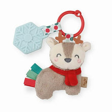 Load image into Gallery viewer, Holiday Reindeer Itzy Pal™ Plush + Teether. Tan reindeer plush with red scarf and ribbons at tail. Blue snowflake teether toy attached on red ring.