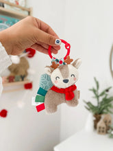 Load image into Gallery viewer, Holiday Reindeer Itzy Pal™ Plush + Teether. Plastic ring can clip onto carseat.