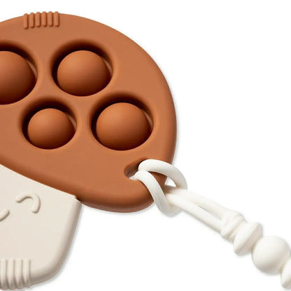 Itzy Pop Mushroom Teether in brown close up of bubbles to pop and hole for clip - Little Gift Nook