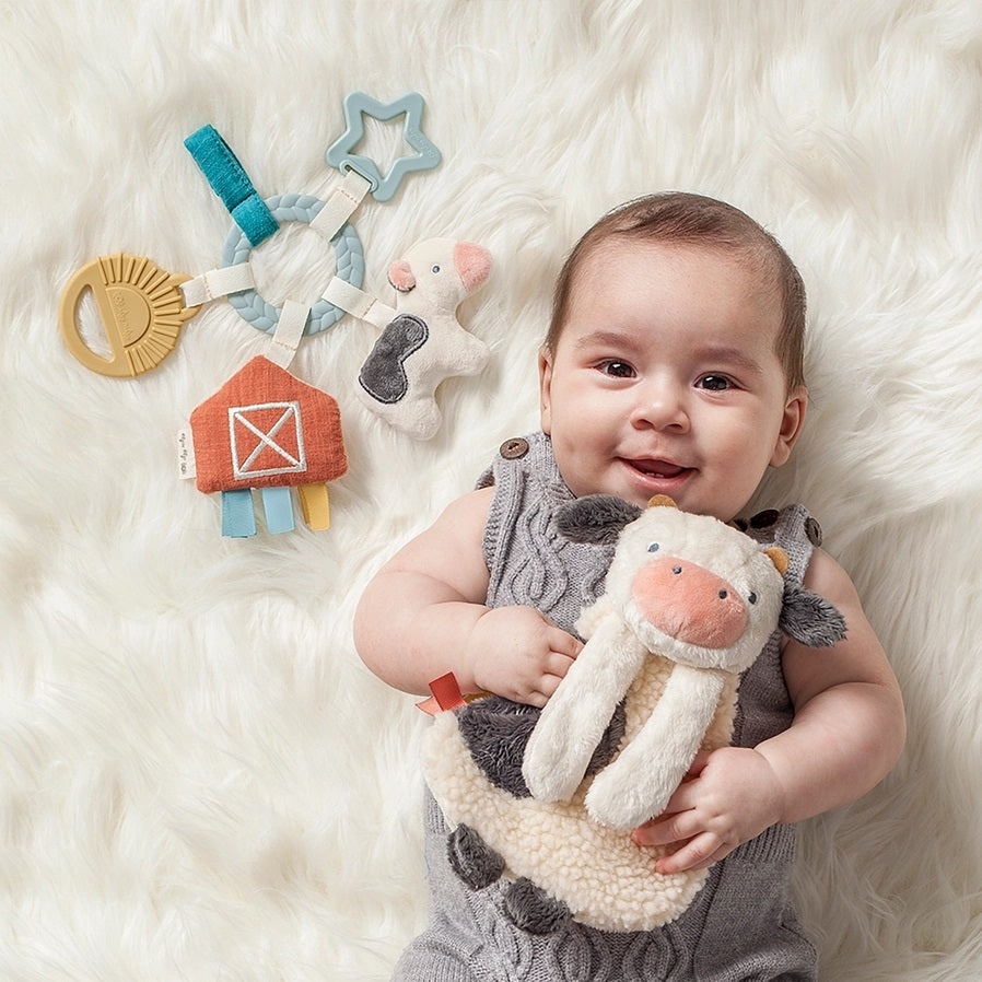 Itzy Ritzy Busy Farm Baby Gift Set. Shown with baby holding cow. - Little Gift Nook