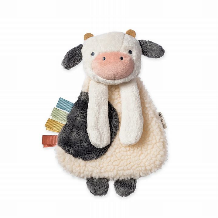 Itzy Ritzy Busy Farm Baby Gift Set. Close up of plush textured cow with taggies on side.- Little Gift Nook