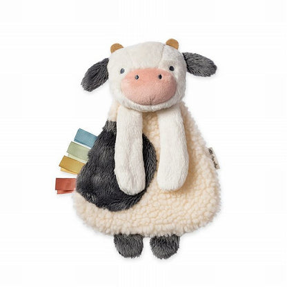 Itzy Ritzy Busy Farm Baby Gift Set. Close up of plush textured cow with taggies on side.- Little Gift Nook