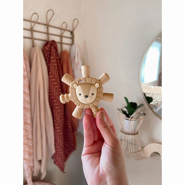 Itzy Ritzy Lion Baby Molar Teether held up to see all 7 legs or hollow tubes that help reach molars - Little Gift Nook