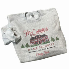 Load image into Gallery viewer, McCallister&#39;s Home Security est. 1990 gray crewneck sweatshirt ~ Adult sizes. Has graphic of house, Christmas tress and Home Security has lock in place of letter O. Cute funny play on Home alone movie. 