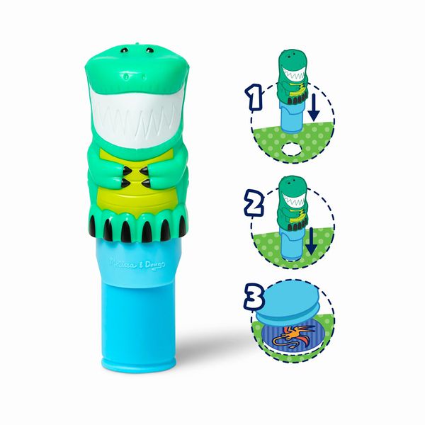 Melissa & Doug Sticker WOW Dinosaur Activity Pad. Sticker stamper is green and shaped like a dinosaur. Push down to reveal a sticker and use activity book and per-designed sticker spots.  - Little Gift Nook