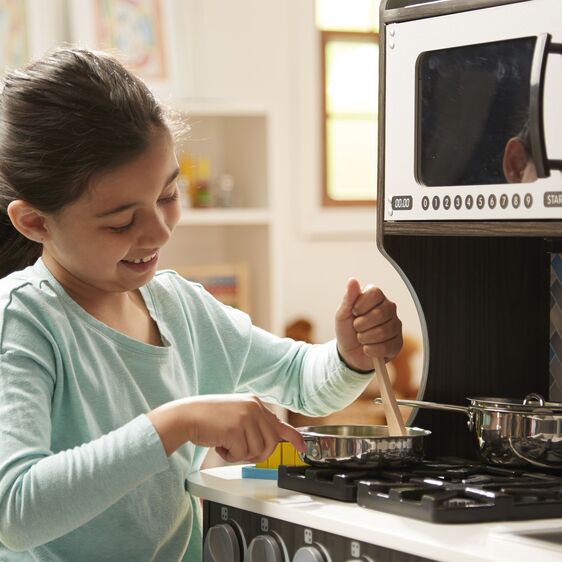 Melissa & Doug Let's Play House! Stainless Steel Pots & Pans. Showing child pretend play cooking with pan on stove of play kitchen. - Little Gift Nook
