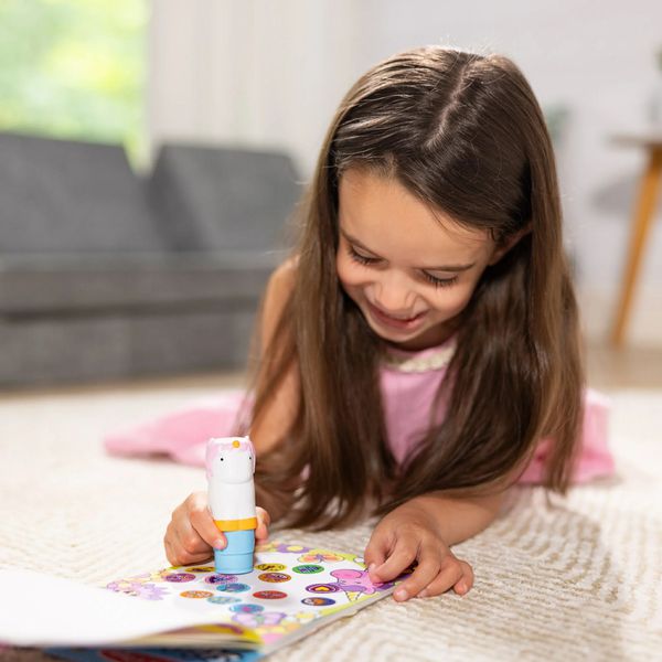 Little girl using the unicorn sticker wow stamper and activity book. Little Gift Nook.