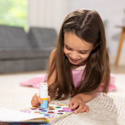 Little girl using the unicorn sticker wow stamper and activity book. Little Gift Nook.