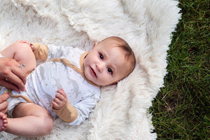 Organic Cotton white, gray, and tan grow with me baby bodysuit. Extra snaps so you get much longer use. Made in India. On baby model.