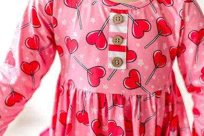 Sucker for Love Hearts Ruffle Twirl Dress. Pink sucker heart print dress with 3 buttons at top decorative only. - Little Gift Nook