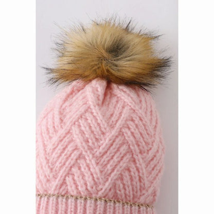 Close up of pink cross cable knit child beanie hat pom pom at top of hat. Faux fur pom pom.- Little Gift Nook