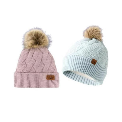 Pink or Blue Knit Pom Pom hats. Pastel pink or blue with tan furry tassel on top.  White super soft lining and very stretchy.  Little Gift Nook.