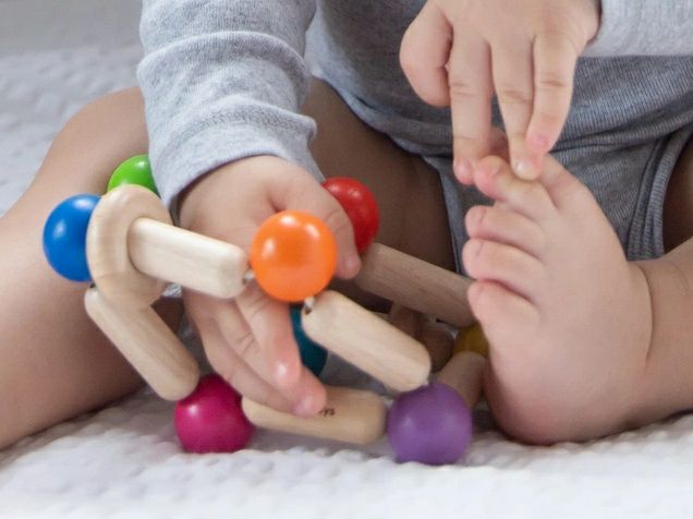 Plan Toys Square Clutching Toy for Baby. Close up of bendable wooden sensory toy. - Little Gift Nook