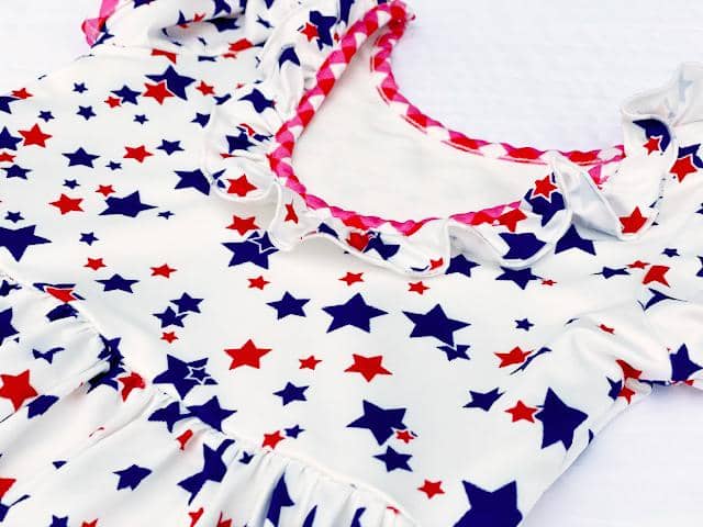 Close up Gingham Red White Blue Stars Ruffle Twirl Dress sz 8/10 laying flat. - Little Gift Nook