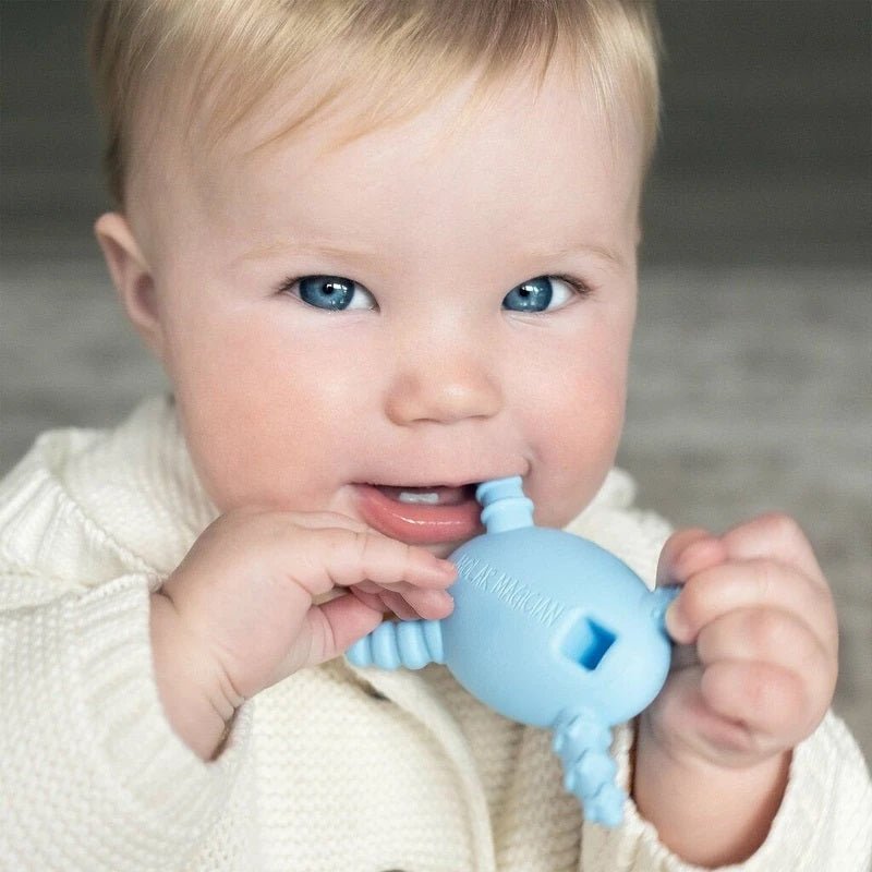 Baby holding The Molar Magician Teether in Blue - Little Gift Nook