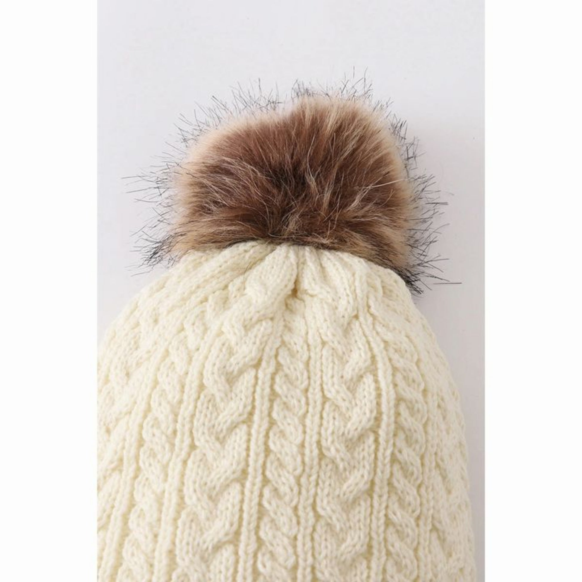 Close up of Cream cable knit pom pom beanie winter hat.- Little Gift Nook