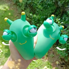 Load image into Gallery viewer, Green worm squeeze fidget eye pop out toy child squeeznig them.