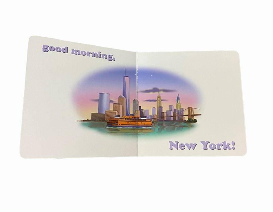 Inside baby board book "Goodnight Yankees" with NY skyline and says Good morning, New York! Book open sitting on white background.