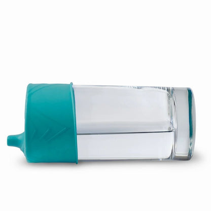 GoSili silicone sippy lid on a glass on its side no spill on a white background. Little Gift Nook