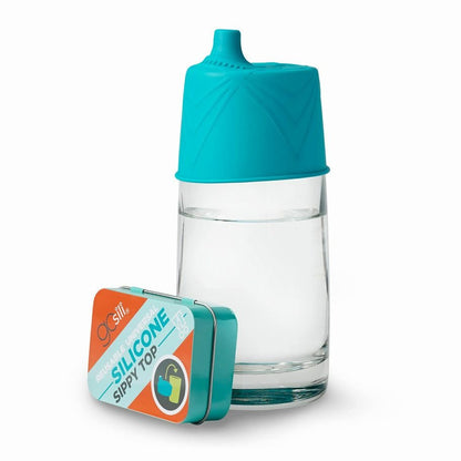 GoSili silicone teal universal sippy top lid on a glass and comes in tinl storage box. Little Gift Nook