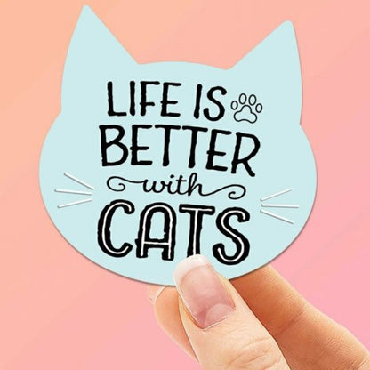 blue cat shaped "Life is Better with cats" waterproof sticker behind held on pink background. Little Gift Nook