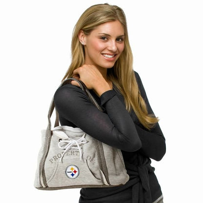 Woman holding NFL Pittsburgh Steelers Hoodie Purse.